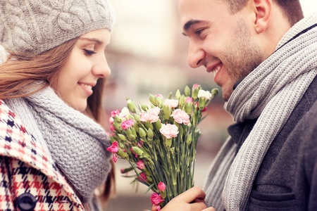 33006659 - a picture of a man giving flowers to his lover on a winter day